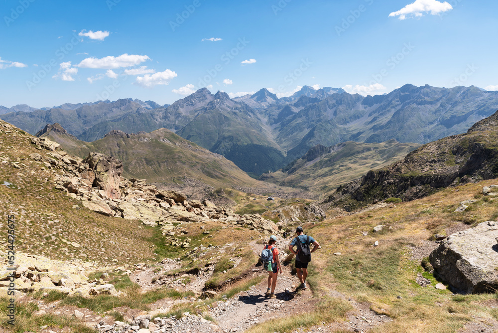Couple of hikers descending from Peyreget. Pyrenees National Park