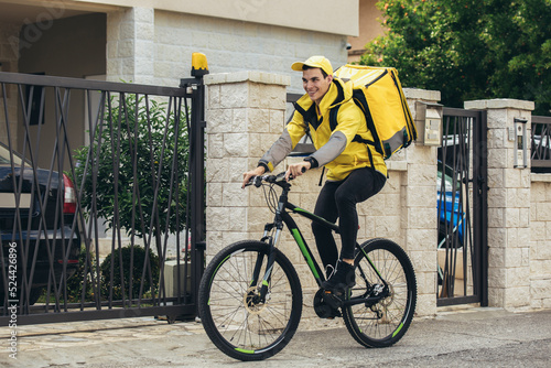 Male courier with bicycle delivering packages photo