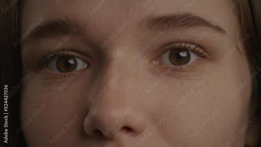 Close up of a caucasian woman eyes in a wink or blink gesture in slow motion Close up of a caucasian woman eyes in a wink or blink gesture in slow motion