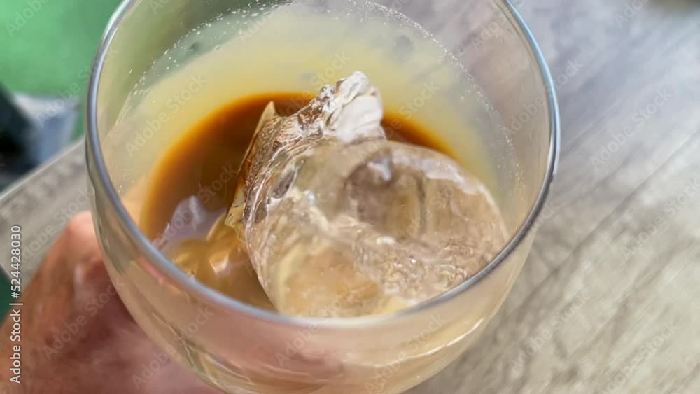 (Slow Motion 240fps) close-up shot moving a glass of iced coffee (Slow Motion 240fps) close-up shot moving a glass of iced coffee