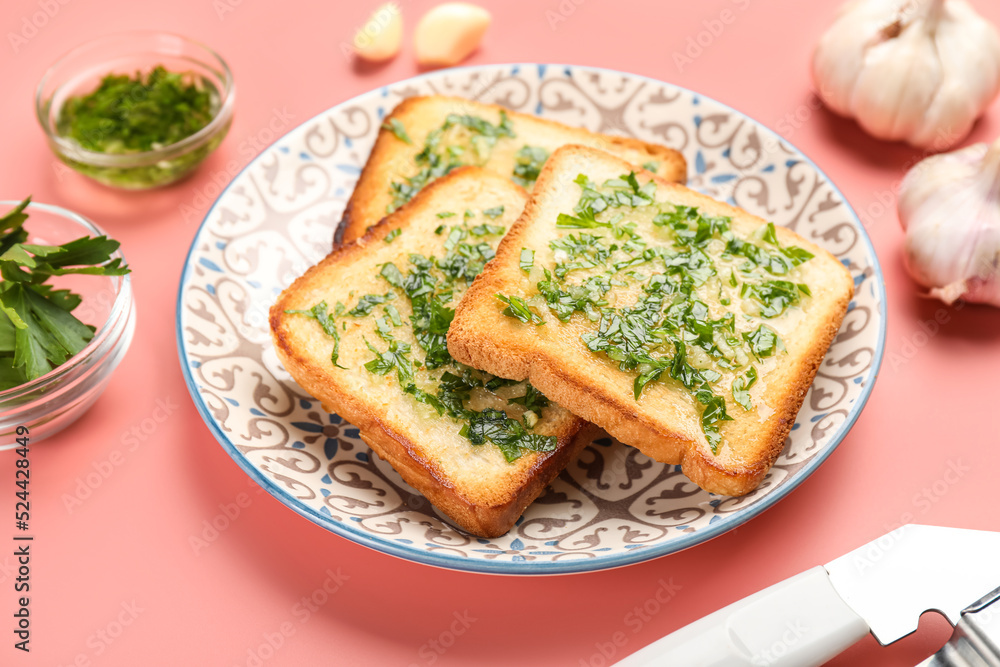 Plate with slices of toasted garlic bread on pink background, closeup Plate with slices of toasted garlic bread on pink background, closeup