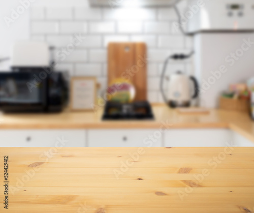 empty wooden tabletop and blurred kitchen mock up for product display