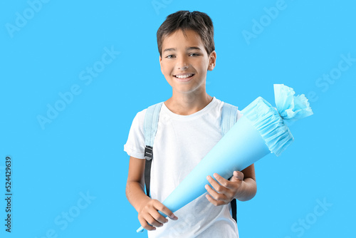 Little boy with school cone...