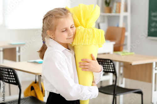 Cute little girl hugging ye...