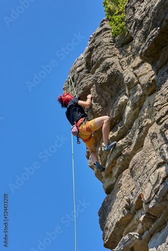Teenage girl in a difficult rock climbing tour in the Rockgarden in Hessigheim, Neckar valley, Baden-Wuerttemberg, Germany 