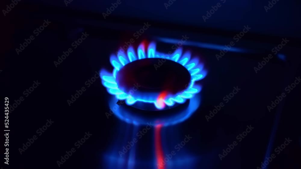 Gas cooktop burning gas stove with blue flame ignited and keeps burning Gas cooktop burning gas stove with blue flame ignited and keeps burning