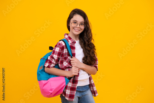 Back to school. Teenage school girl ready to learn. School children on yellow isolated background. Happy teenager, positive and smiling emotions of teen girl.