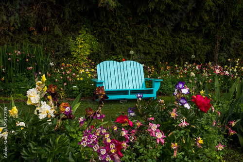 Fototapeta Naklejka Na Ścianę i Meble -  Bench in the park in flowers environment