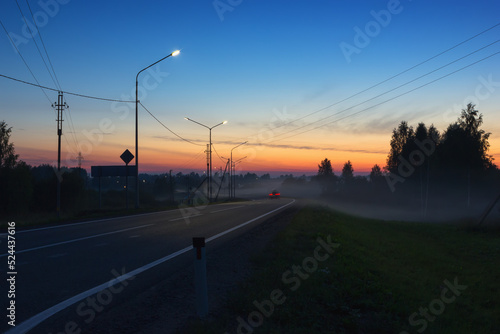 Night Country Highway Illuminated by Street Lamps at Sunset
