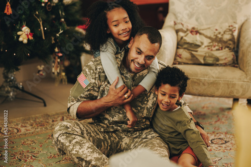 Cherful military family spending Christmas together at home photo