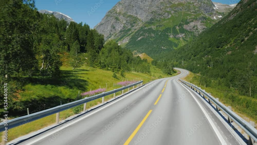 Travelling on a scenic road among the mountains in Norway Travelling on a scenic road among the mountains in Norway