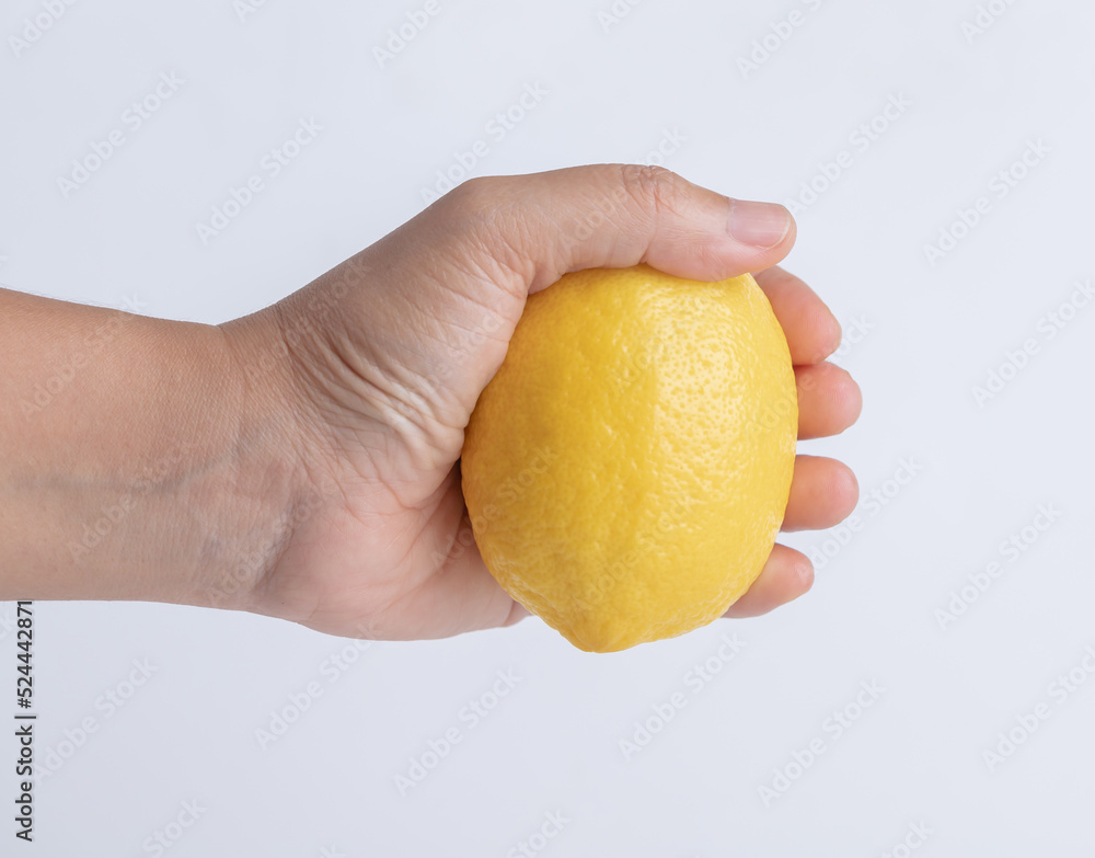 Hand woman holding ripe lemon isolated Hand woman holding ripe lemon isolated