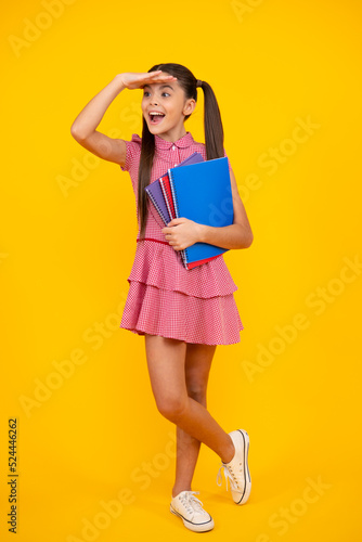 Teenager school girl study with books. Learning knowledge and kids education concept. Happy teenager, positive and smiling emotions of teen schoolgirl.