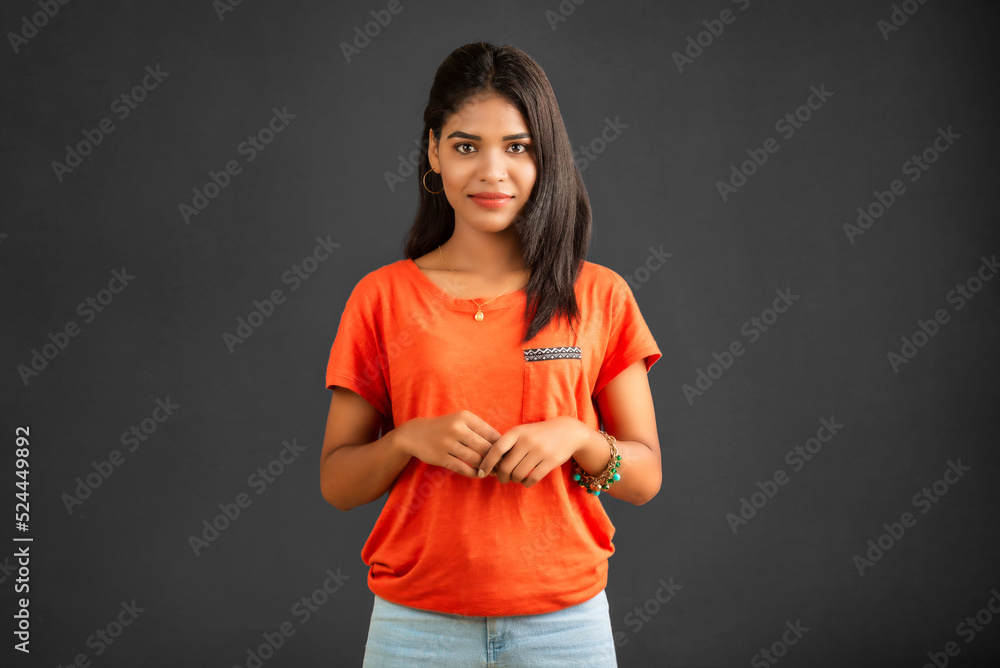 simple portrait of a young beautiful girl posing on gray background simple portrait of a young beautiful girl posing on gray background