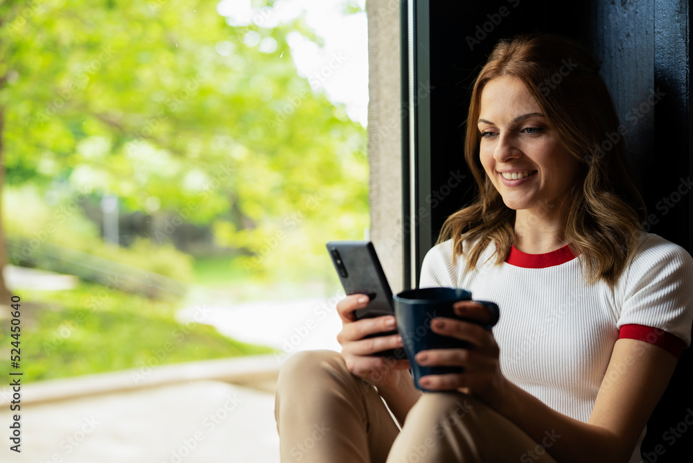 Young businesswoman drinking coffee in her office. Young businesswoman drinking coffee in her office.