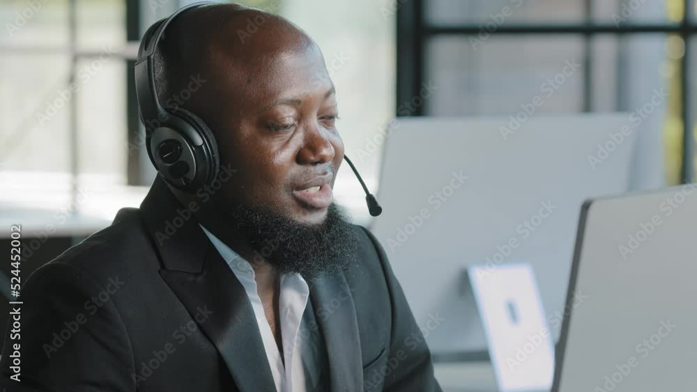 African american business person ceo consultant lawyer advisor recruiter hr manager in headphones with microphone talking at computer webcam consulting online interviewing distant negotiation remotely African american business person ceo consultant lawyer advisor recruiter hr manager in headphones with microphone talking at computer webcam consulting online interviewing distant negotiation remotely