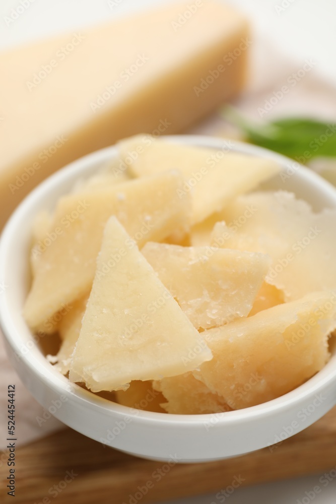 Bowl with parmesan cheese pieces on table, closeup Bowl with parmesan cheese pieces on table, closeup