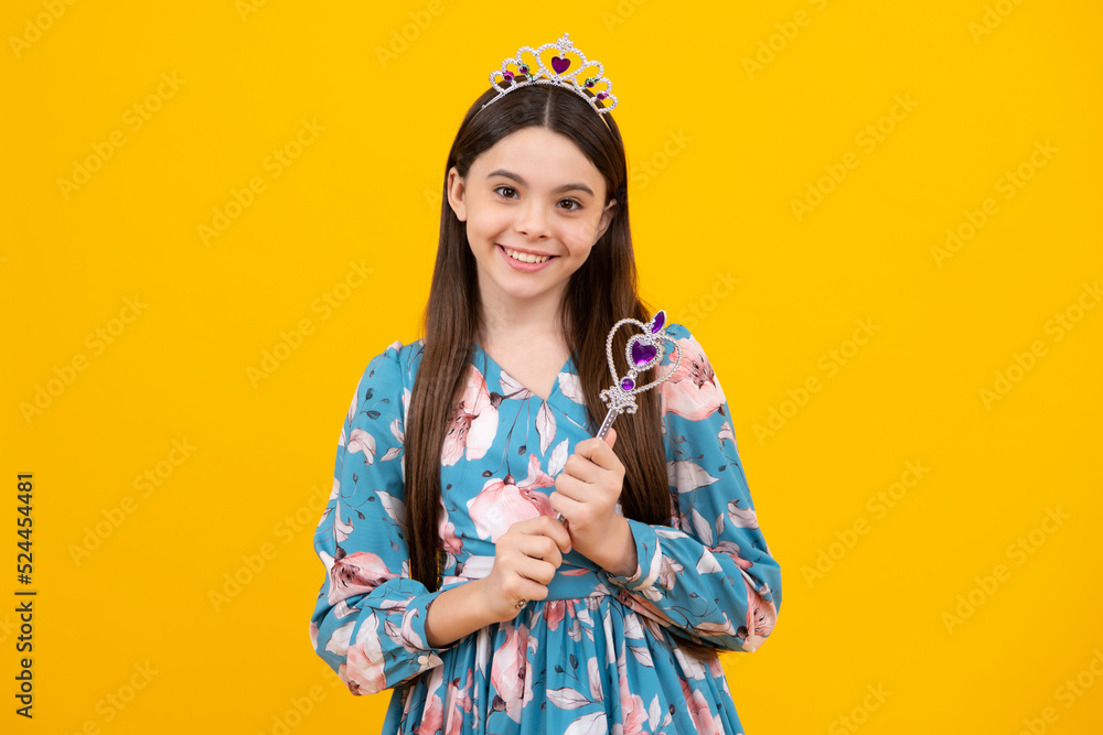 Portrait of happy girl princess in tiara holding magic wand. Teenager queen with golden crown. Portrait of happy girl princess in tiara holding magic wand. Teenager queen with golden crown.