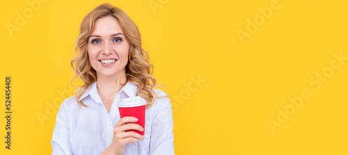 cheerful blonde woman with morning coffee cup on yellow background. Woman isolated face portrait, banner with mock up copy space.