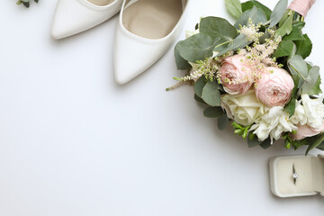 Composition with wedding high heel shoes on white background, top view