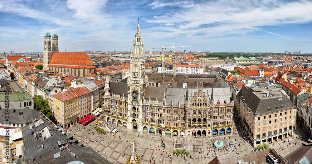 Fototapeta premium Panoramic view of the old medieval Gothic architecture City Hall building at Marienplatz. Square. Munich, GERMANY - August 2022