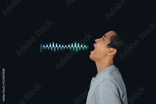 Young man shouting and screaming loud to side with hand on mouth with sound waves. photo
