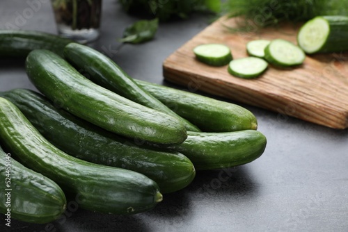 Fresh ripe cucumbers on grey table, closeup