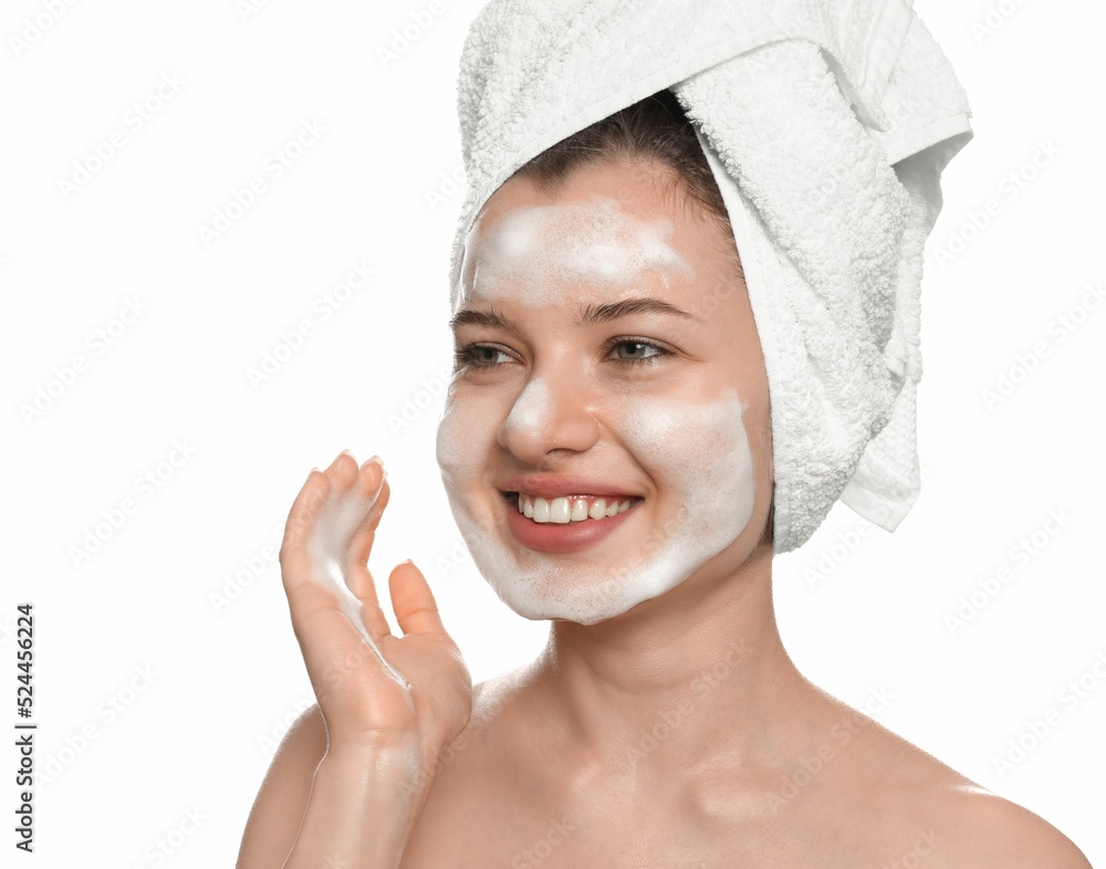 Young woman washing face with cleansing foam on white background. Skin care cosmetic Young woman washing face with cleansing foam on white background. Skin care cosmetic