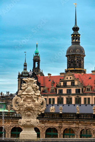 Decorative vase on the upper gallery of Zwinger complex with the city view at the background, Dresden