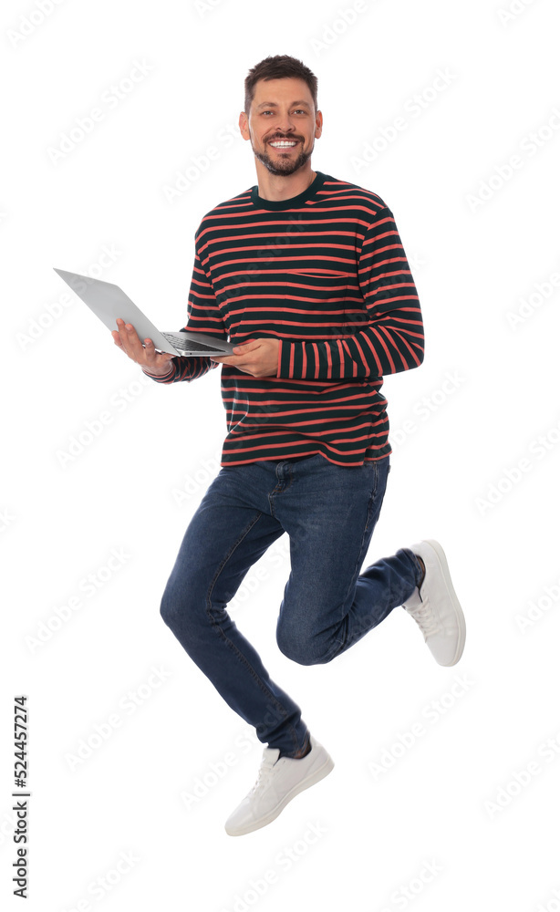Handsome man with laptop jumping on white background Handsome man with laptop jumping on white background