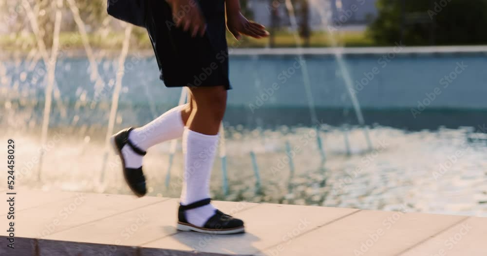 The schoolgirl goes to school for a lesson. African american teenager with a backpack joyfully runs early in the morning in the park to study, concept child studying at school