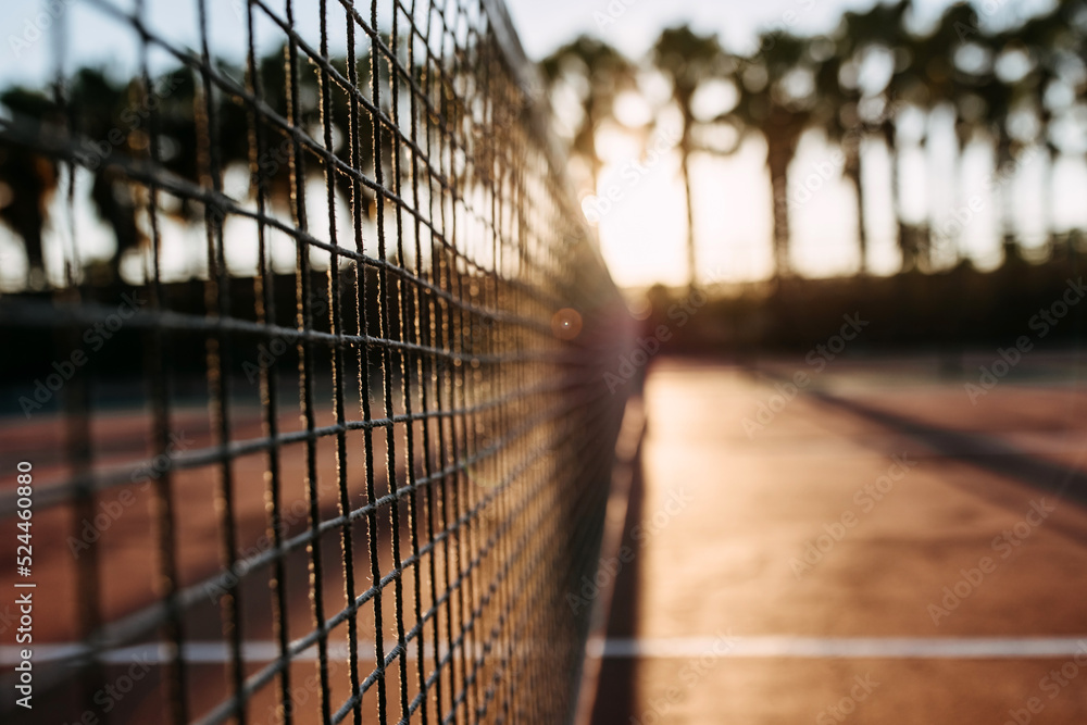 Closeup of a net on a tennis court in sunrise sun light, outdoors. Closeup of a net on a tennis court in sunrise sun light, outdoors.