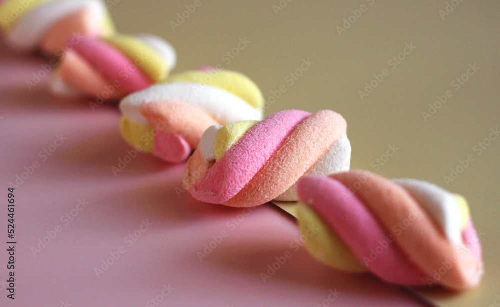 dessert multi-colored air marshmallows on a pink background