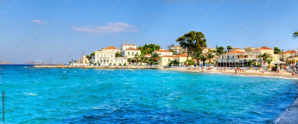  A view of the beach skyline of the beautiful Greek Island, Spetses, the coastline leading to the city and some of the local architecture.