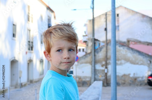 Canvas Print The blond boy pursed his lips and looked sadly into the distance