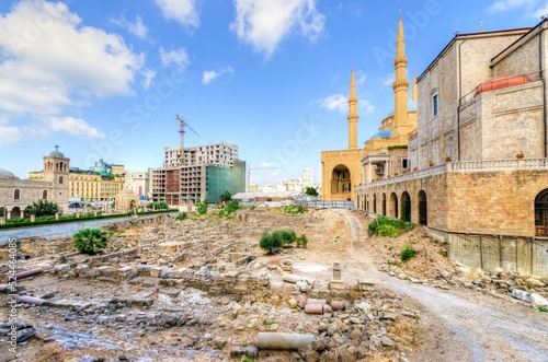 A view of the Saint George Maronite Cathedral and the Mohammad Al-Amin Mosque at the historic centre of Beirut, in Lebanon, down town. Ancient Roman, Hellenistic, Byzantine ruins on the foreground. photo