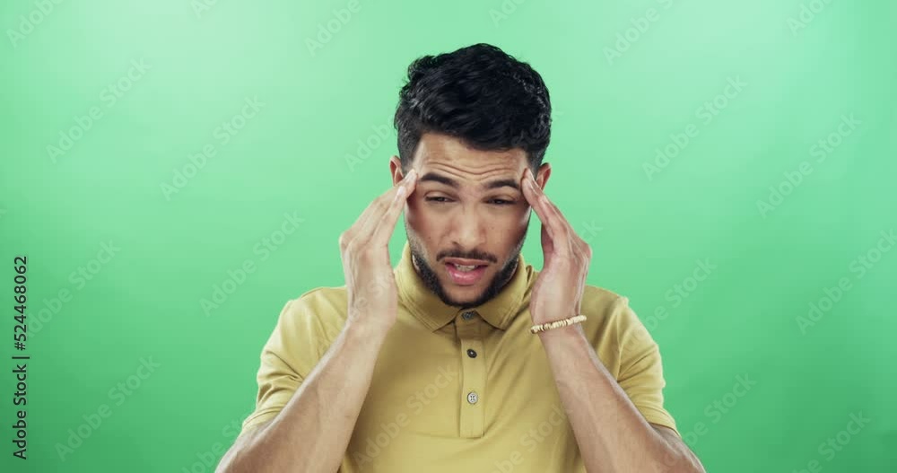 Wheres a painkiller when you need one. 4k video footage of a young man suffering from a headache against a green studio background. Wheres a painkiller when you need one. 4k video footage of a young man suffering from a headache against a green studio background.