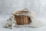 Baby nest with basket and knitted blanket