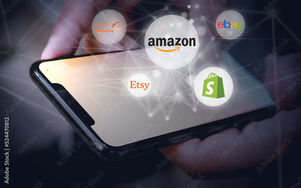 Logos of the online marketplace, shopping apps Amazon, Shopify, etsy, eBay,  alibaba.com hovering over a smartphone and a lighten grid, consumption,  sale, purchase, internet Stock Photo | Adobe Stock