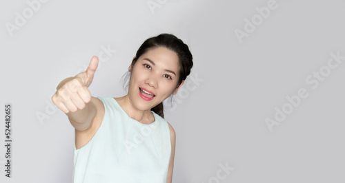 Wallpaper Mural Asian beautiful woman make thumbs up hand sign gesture to encourage people with smile and happiness Torontodigital.ca