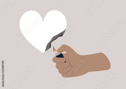 A hand burning a paper heart with a lighter, relationship difficulties