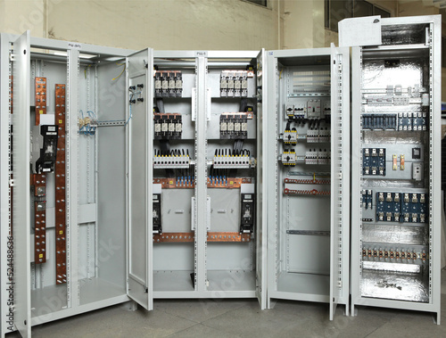 Electrician engineer work tester measuring voltage and current of power electric line in electical cabinet control.and wires on relay protection system. Bay control unit. Medium voltage switchgear.