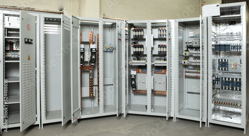 Electrician engineer work tester measuring voltage and current of power electric line in electical cabinet control.and wires on relay protection system. Bay control unit. Medium voltage switchgear.