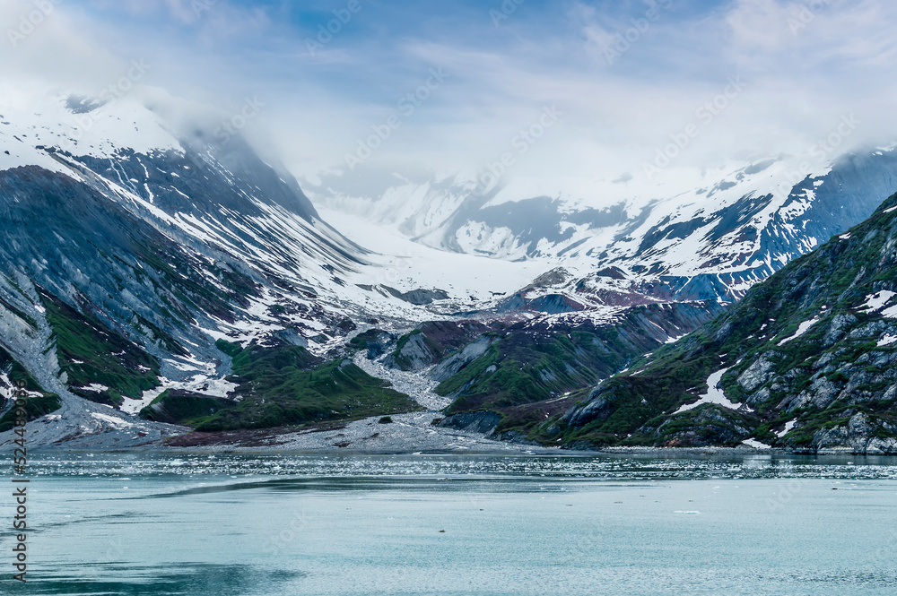 A view of snow filled valleys and moraine on the sides of Glacier Bay, Alaska in summertime