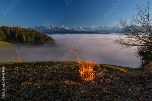 Camp fire before  sea of fog and swiss alps at sunset © Doris Marolf