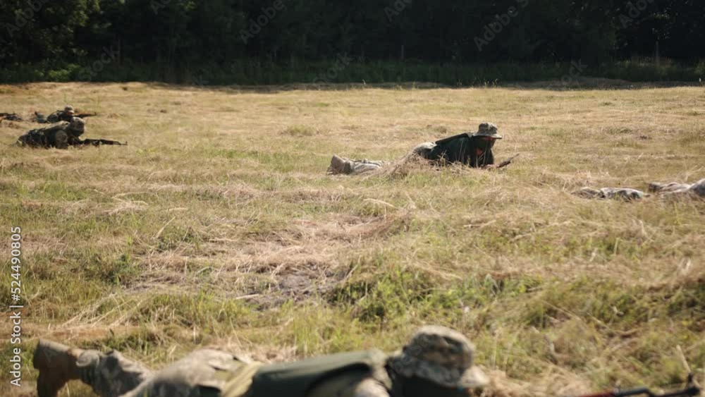 Military Special Forces Unit of soldiers with weapons and ammunition are on the battlefield, attacking the enemy Military Special Forces Unit of soldiers with weapons and ammunition are on the battlefield, attacking the enemy