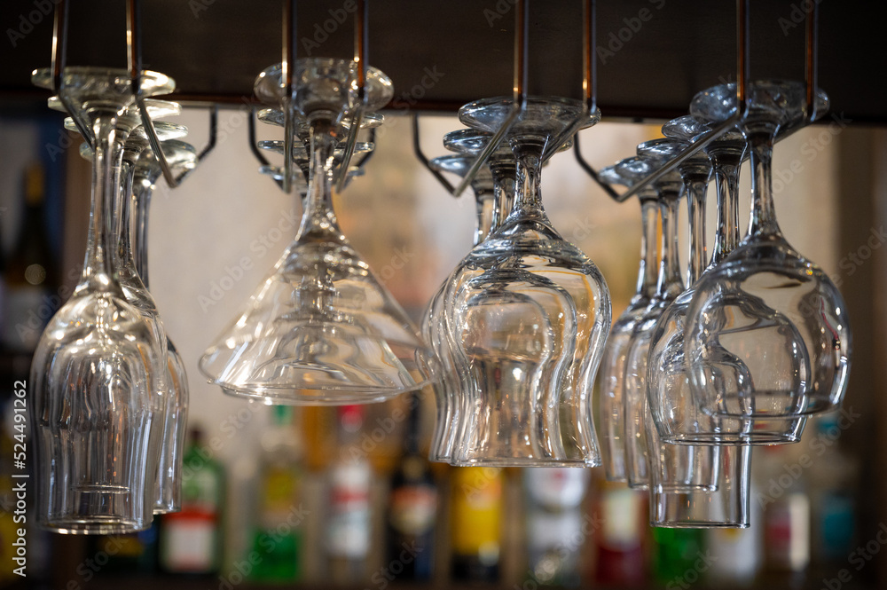 Set of glasses are hanging on the bar