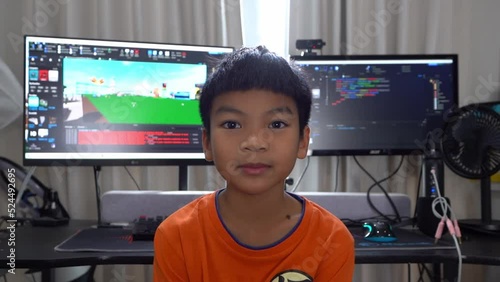 Kid with computer programming and game developing in background, for technology coding concept.