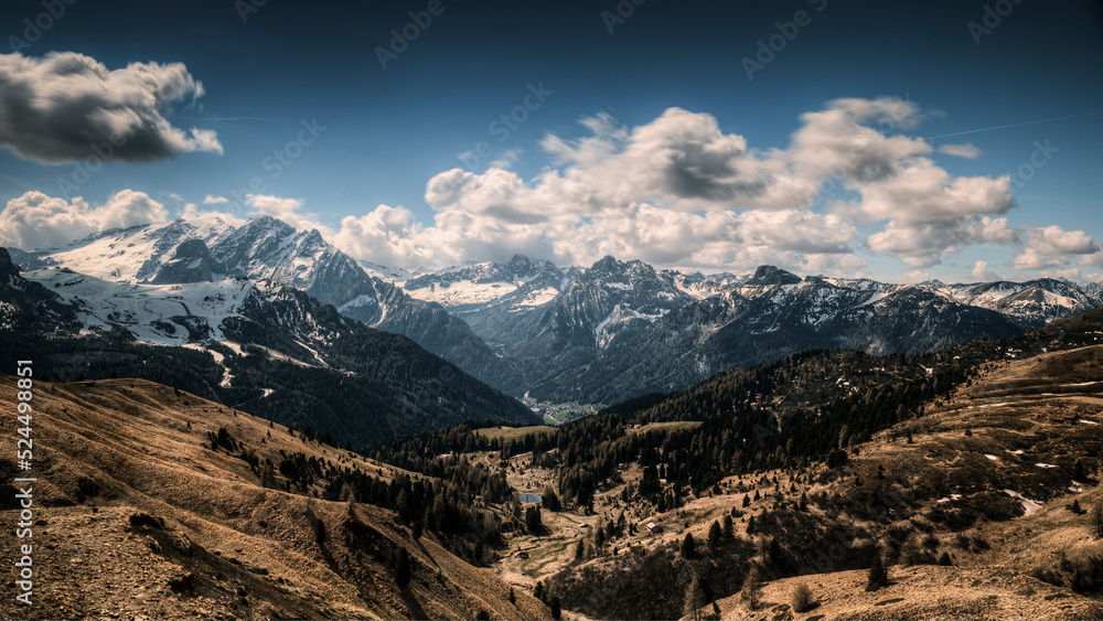 Passo Gardena, (Bz) in June 2022, you can see the morning light on the morning clouds, with the mountains with the last spring snow. You can see the valley, dried up by a particularly dry winter that 