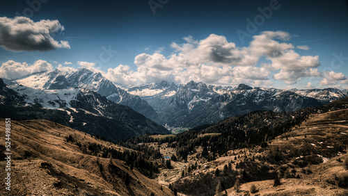 Passo Gardena   Bz  in June 2022  you can see the morning light on the morning clouds  with the mountains with the last spring snow. You can see the valley  dried up by a particularly dry winter that 